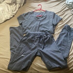 Gray scrubs still in good condition. Top is a small pants are xs tall